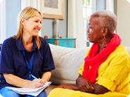 caregiver talking to her senior patient